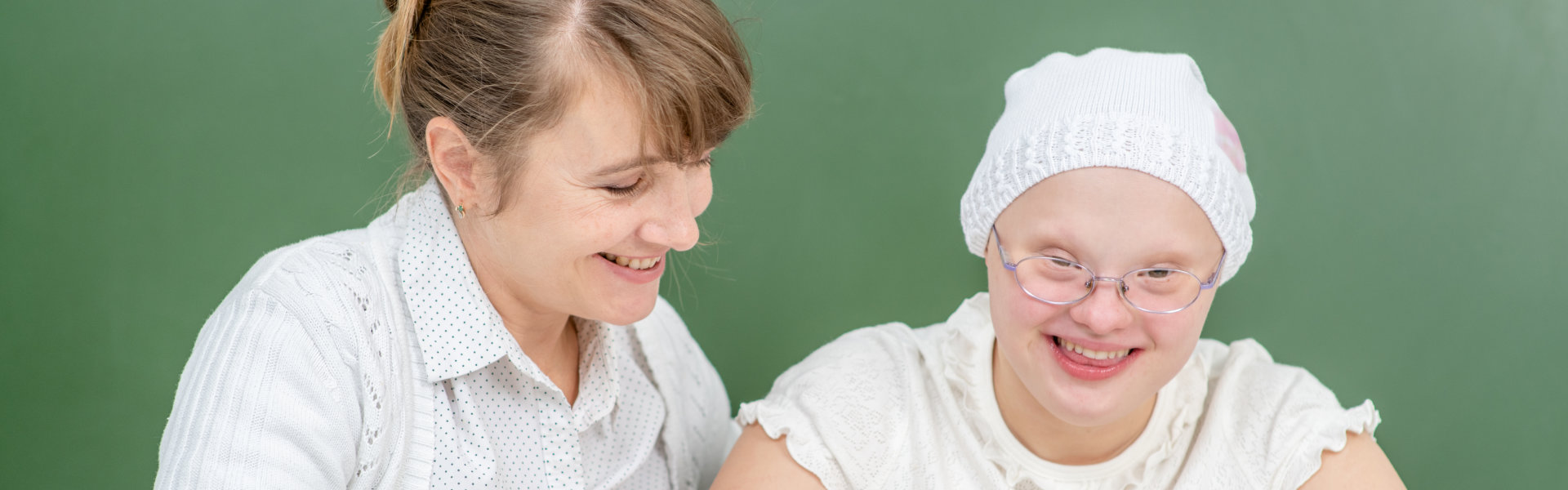 a woman and a girl smiling at the camera