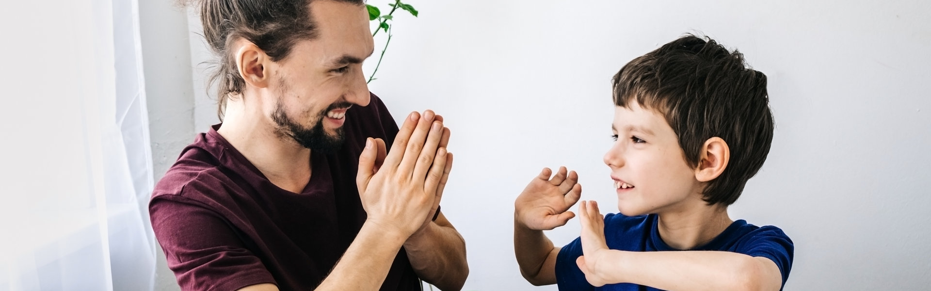 a man with a little boy smiling and playing