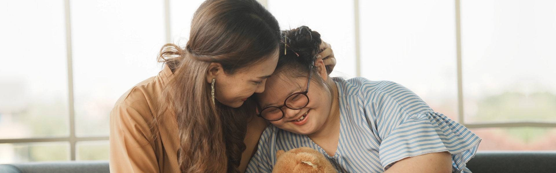 a woman hugging a little girl